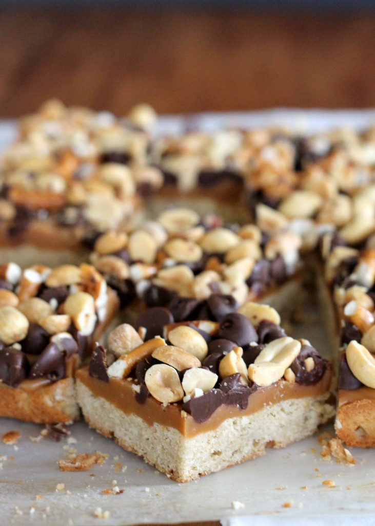 Fully Loaded Bars | Oat shortbread crust, peanut butter caramel, roasted peanuts, pretzels, and semi-sweet chocolate chips! [from bakerita.com]