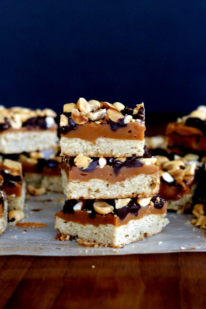 Fully Loaded Bars | Oat shortbread crust, peanut butter caramel, roasted peanuts, pretzels, and semi-sweet chocolate chips! [from bakerita.com]