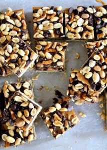 Fully Loaded Bars | Oat shortbread crust, peanut butter caramel, roasted peanuts, pretzels, and semi-sweet chocolate chips! [from bakerita.com]