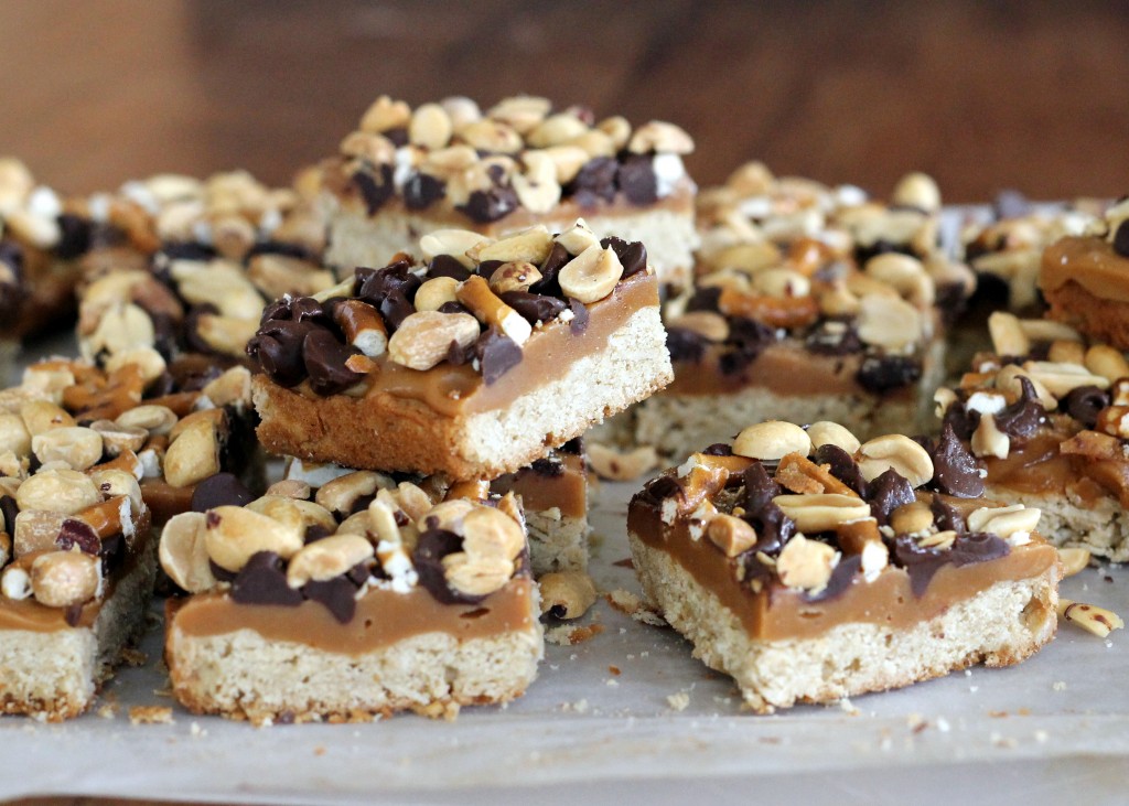 Fully Loaded Bars | Oat shortbread crust, peanut butter caramel, roasted peanuts, pretzels, and semi-sweet chocolate chips! [from bakerita.com]