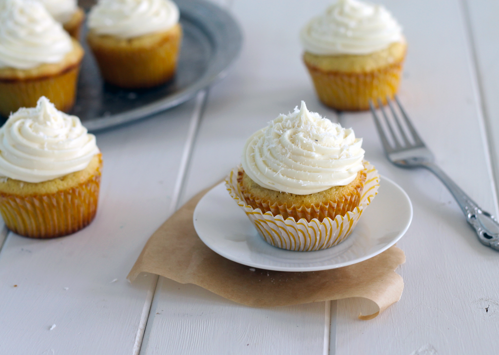 Coconut Cupcakes with White Chocolate Cream Cheese Frosting (and they're stuffed with a truffle!) | Bakerita.com