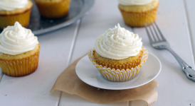 Coconut Cupcakes with White Chocolate Cream Cheese Frosting (and they're stuffed with a truffle!) | Bakerita.com