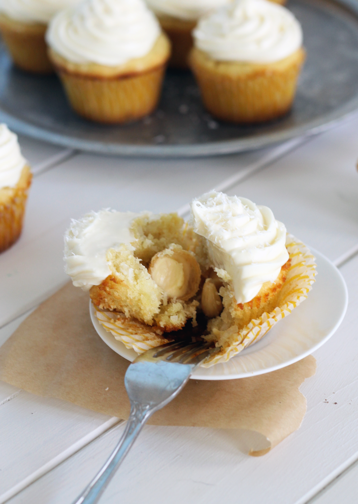 Coconut Cupcakes with White Chocolate Cream Cheese Frosting (and they're stuffed with a truffle!) | Bakerita.com