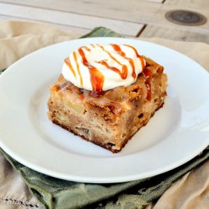 This Caramel-Glazed Apple Cake is an amazingly moist and delicious apple cake full of spices and topped with caramel sauce and caramel whipped cream!