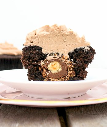 These Chocolate Cupcakes with Nutella Buttercream have a Ferrero Rocher truffle stuffed inside! Everyone will love these surprise inside cupcakes.
