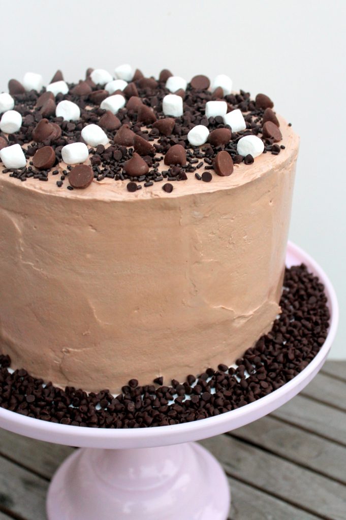 This Midnight Binge Cake has layers of chocolate cake, chocolate chip cookies, and chocolate chip cookie dough, sandwiched with creamy chocolate fudge frosting & whipped chocolate marshmallow frosting! This is one decadent celebration cake recipe sure to impress.