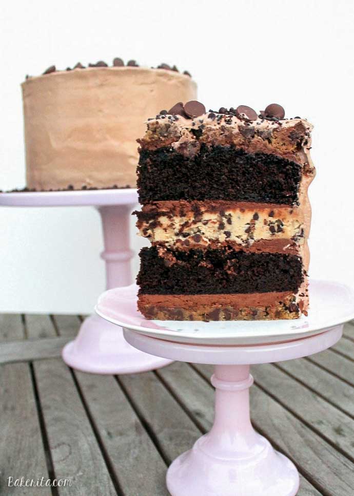This Midnight Binge Cake has layers of chocolate cake, chocolate chip cookies, and chocolate chip cookie dough, sandwiched with creamy chocolate fudge frosting & whipped chocolate marshmallow frosting! This is one decadent celebration cake recipe sure to impress.
