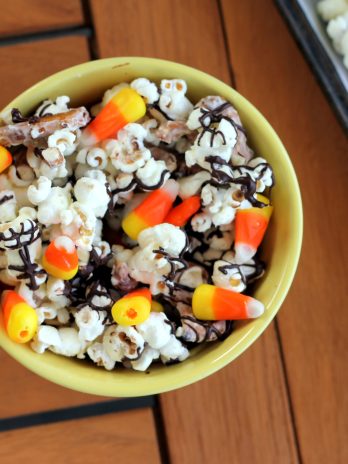 This White Chocolate Candy Corn Popcorn is tossed with with pretzels, candy corn, white chocolate, and a drizzle of dark chocolate for a Halloween treat!