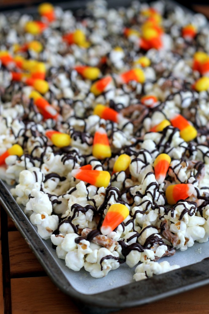 This White Chocolate Candy Corn Popcorn is tossed with with pretzels, candy corn, white chocolate, and a drizzle of dark chocolate for a Halloween treat!