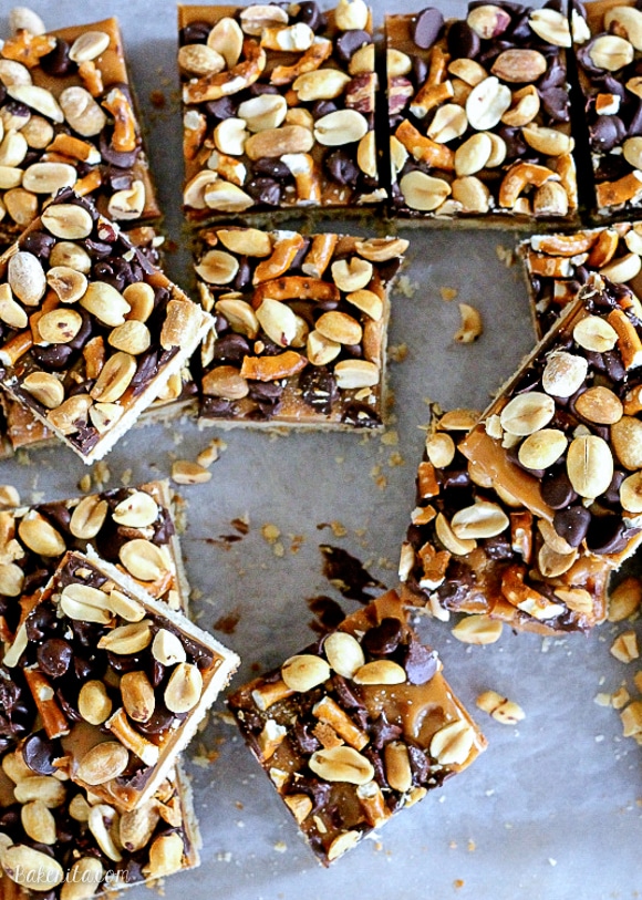 These Fully Loaded Bars have an oat shortbread crust topped with peanut butter caramel, pretzels, chocolate chips, and roasted peanuts. They're irresistible!