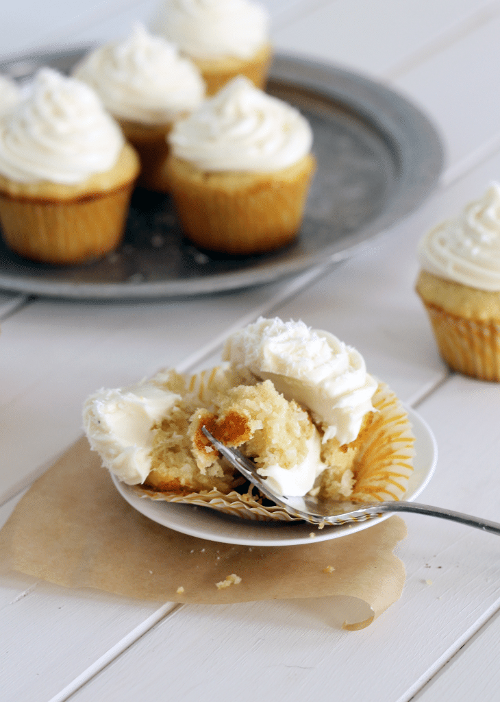 These soft and sweet Coconut Cupcakes have a coconut truffle stuffed in the middle, and are topped with an tangy, creamy white chocolate cream cheese frosting! This irresistible treat with be a favorite of any coconut lover.