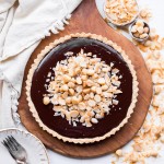 This Dark Chocolate, Coconut & Macadamia Nut Tart is decadent, delicious and easy to make. It has a coconut crust that's filled with a luscious chocolate ganache and topped with toasted coconut and macadamia nuts. You'd never guess that this nutty tart is gluten-free, vegan, Paleo, and refined sugar-free!