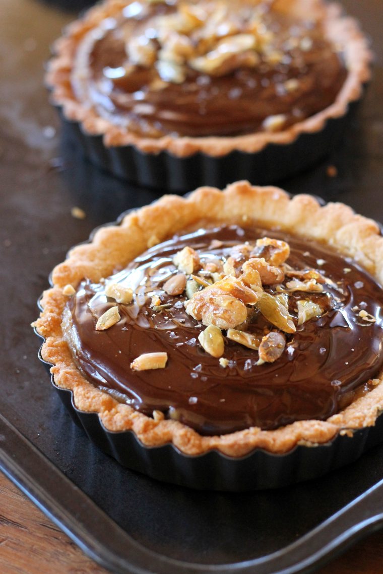Chocolate Date Caramel Tarts have a cookie-like crust made with almond flour and coconut oil. This decadent paleo treat is free of refined sugar, gluten-free and vegan. #vegantart #glutenfree #paleodessert #tartrecipe