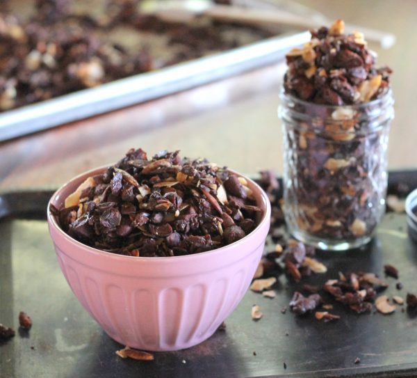 This Chocolate Coconut Paleo Granola is a flavorful and crunchy snack to keep you fueled all morning! This paleo friendly granola uses nuts and coconuts as the base for a delicious gluten-free + vegan breakfast! #breakfast #snack #paleo #vegan #glutenfree #granola