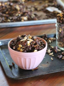 This Chocolate Coconut Paleo Granola is a flavorful and crunchy snack to keep you fueled all morning! This paleo friendly granola uses nuts and coconuts as the base for a delicious gluten-free + vegan breakfast! #breakfast #snack #paleo #vegan #glutenfree #granola