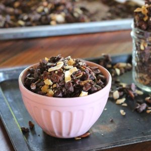 This Chocolate Coconut Paleo Granola is a flavorful and crunchy snack to keep you fueled all morning! This paleo friendly granola uses nuts and coconuts as the base for a delicious gluten-free + vegan breakfast! #breakfast #snack #paleo #vegan #glutenfree #granola