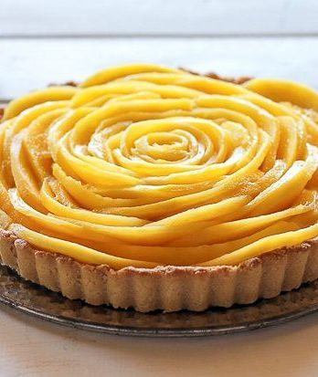This Mango Tart uses fresh, ripe mangos and coconut cream to make a delicious dessert that's gluten-free, Paleo friendly, refined sugar-free, and vegan! The recipe includes step by step photos for how to make a beautiful mango flower.