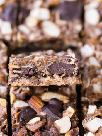 These Paleo Magic Cookie Bars are just as rich and delicious as the classic seven layer bars you know and love! This gluten-free, vegan, and refined sugar free version has an almond flour crust and homemade coconut milk caramel.