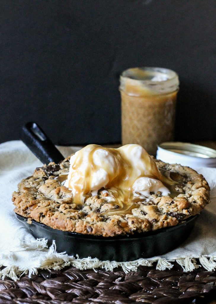This Salted Caramel Filled Dark Chocolate Chunk Skillet Cookie is gooey, crunchy, and flowing with salted caramel! This is one treat best served with ice cream and friends.