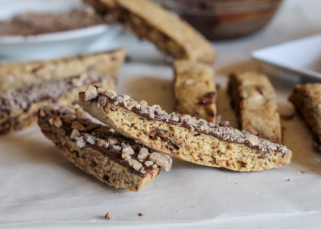 These Chocolate Dipped Toffee Biscotti are the perfect addition to your holiday cookie platter, and taste miles better than rock-hard store bought biscotti! | Recipe from Bakerita.com