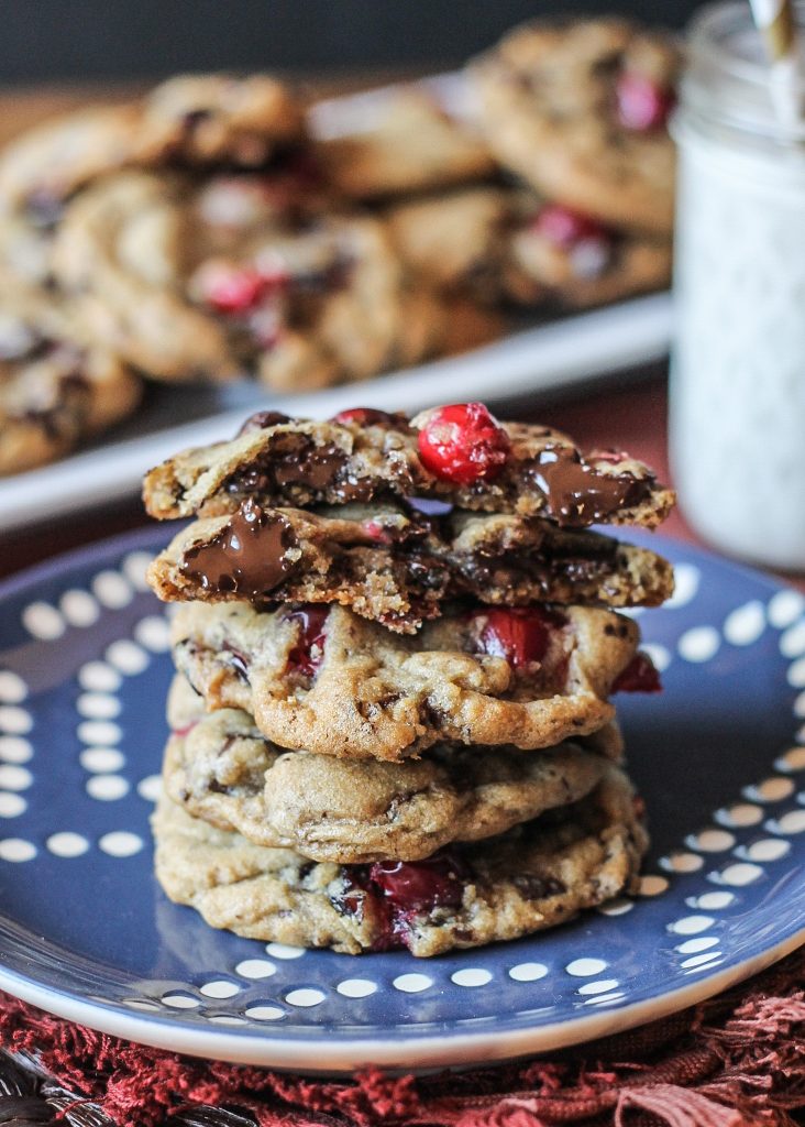 These Double Cranberry Dark Chocolate Chunk Cookies feature a browned butter and nutmeg dough studded with chocolate chunks & cranberries, both dried and fresh! They're the perfect addition to your holiday cookie platters. Recipe from Bakerita.com