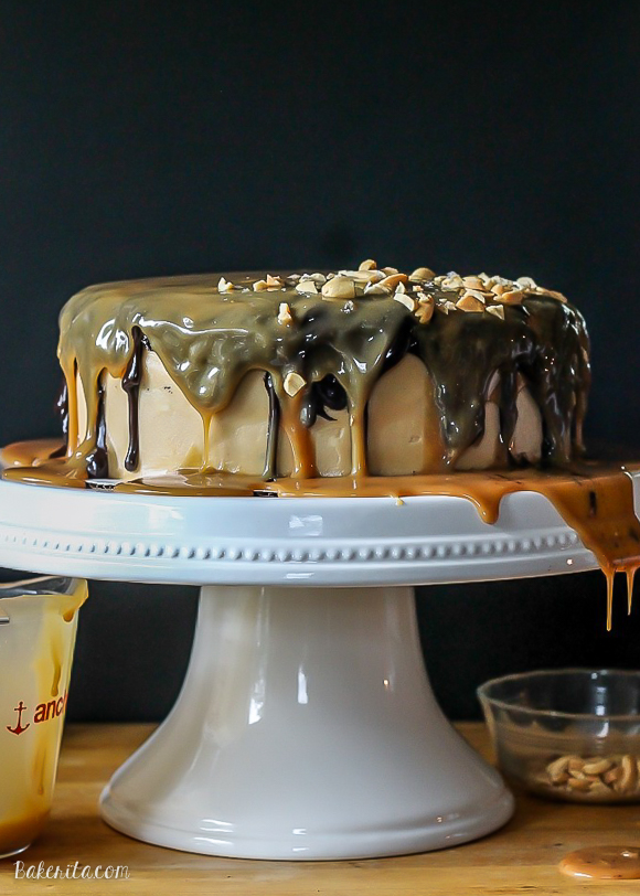 This Ultimate Snickers Cake is six-layers of chocolate cake with peanut caramel filling and peanut butter cream cheese frosting, dripping with chocolate ganache and caramel sauce. It tastes just like a Snickers bar!