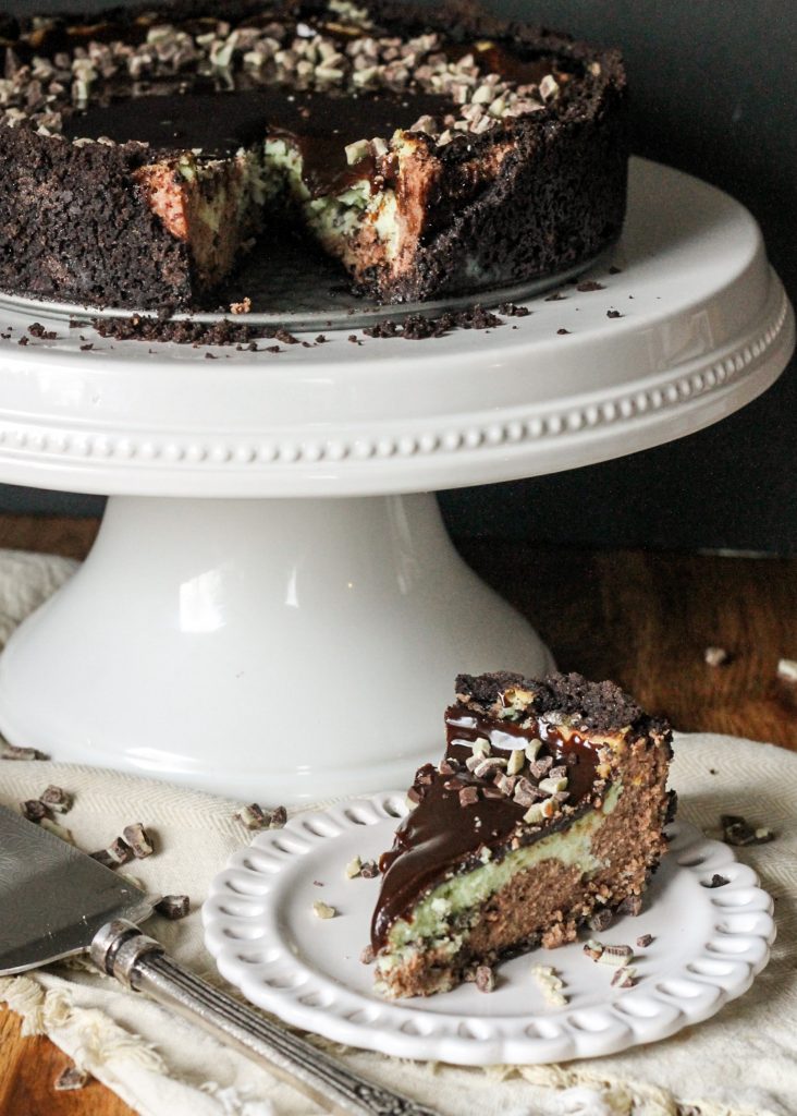 This Mint Chocolate Chip Cheesecake has a chocolate cheesecake layer topped with a minty green cheesecake layer on an Oreo crust. It's the perfect decadent holiday treat!