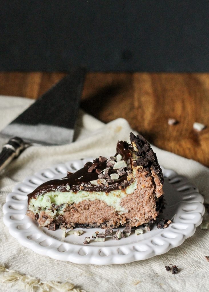 This Mint Chocolate Chip Cheesecake has a chocolate cheesecake layer topped with a minty green cheesecake layer on an Oreo crust. It's the perfect decadent holiday treat!