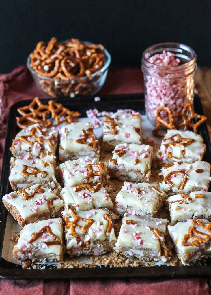 These Peppermint White Chocolate Pretzel Bars have a salty-sweet pretzel crust, a sugar cookie-style bar that's loaded with peppermint and white chocolate, all topped with melted white chocolate and more peppermint!