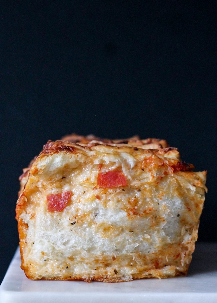 This Pepperoni Pizza Pull Apart Bread features soft layers of homemade bread loaded with tomato sauce, cheese, and pepperoni for an appetizer that's sure to be a fan favorite.