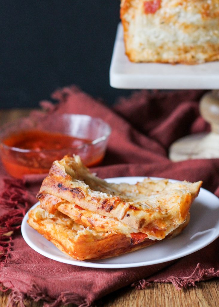 This Pepperoni Pizza Pull Apart Bread features soft layers of homemade bread loaded with tomato sauce, cheese, and pepperoni for an appetizer that's sure to be a fan favorite.