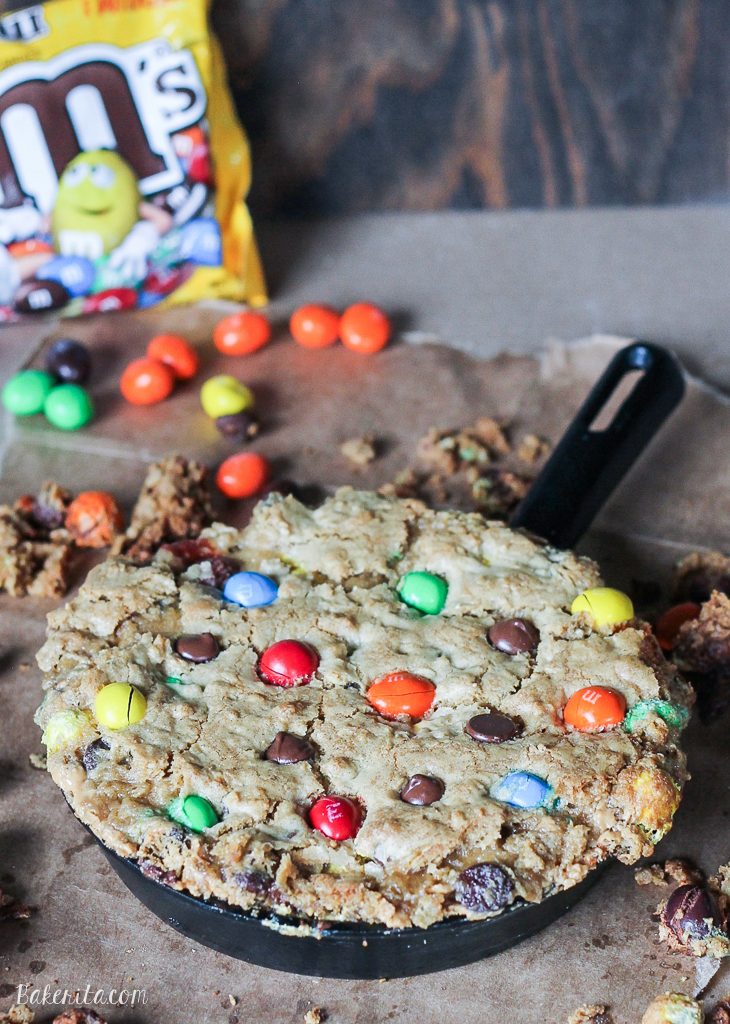 This Oatmeal M&M Peanut Butter Skillet Cookie is a quick and easy recipe made in one bowl that's perfect for sharing! It has a layer of peanut butter in the middle and lots of crispy edges. Top it with ice cream for a homemade version of the pizookie!