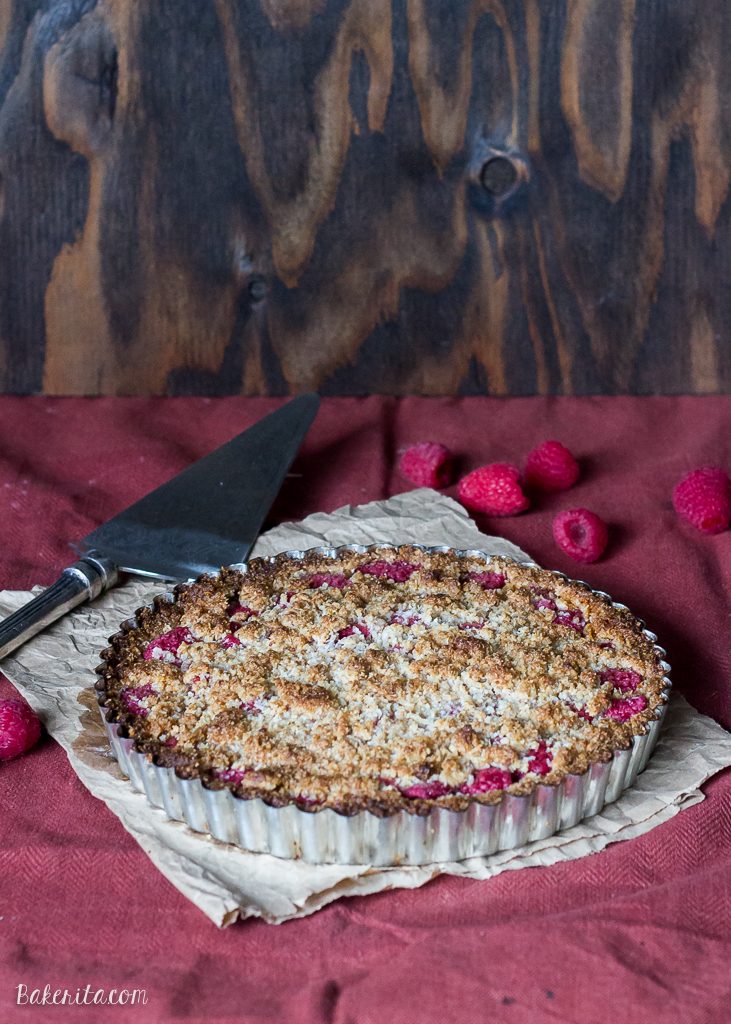 This Raspberry Coconut Crumble Tart has an almond coconut crust that doubles as a crumble topping, filled with fresh raspberries! This easy recipe is Paleo-friendly, gluten free, refined sugar free, and vegan.