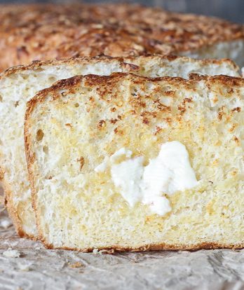 This Cheesy English Muffin Bread is an easy to make bread dough that comes together quickly and is full of cheddar cheese! It bakes into a beautiful loaf that's perfect for toasting.