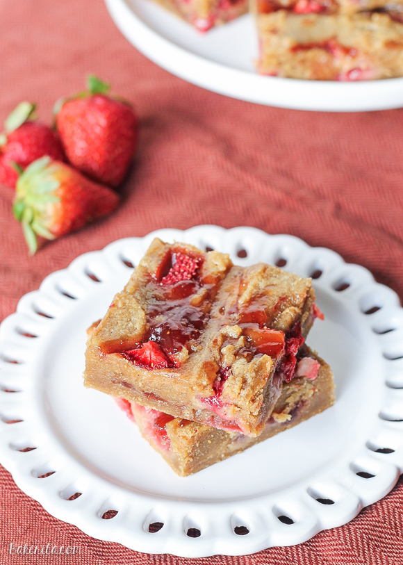 Fresh strawberries and strawberry jelly are swirled into soft peanut butter blondies to create these Peanut Butter & Jelly Bars that taste just like your favorite childhood sandwich! They're super easy and come together in one-bowl.
