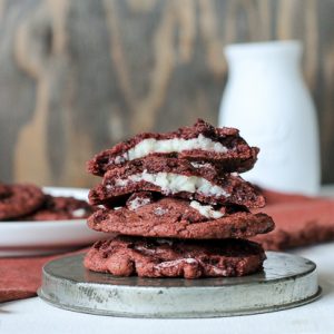 These Red Velvet Oreo Cookies with Cream Cheese Filling are from-scratch red velvet cookies with Red Velvet Oreos and mini chocolate chips folded in. The center has a luscious sweet cream cheese filling. These are some decadent cookies!