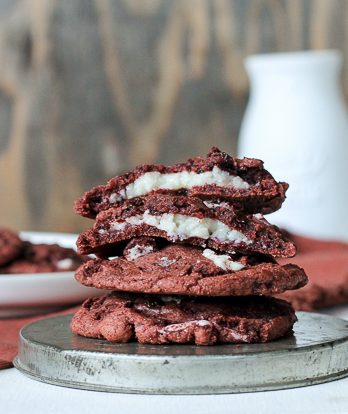 These Red Velvet Oreo Cookies with Cream Cheese Filling are from-scratch red velvet cookies with Red Velvet Oreos and mini chocolate chips folded in. The center has a luscious sweet cream cheese filling. These are some decadent cookies!
