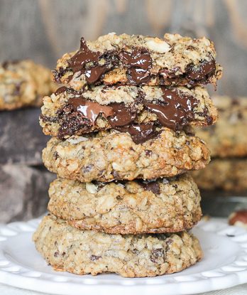 These Nutella Stuffed Oatmeal Hazelnut Chocolate Chip Cookies are loaded with dark chocolate and sprinkled with sea salt. Crunchy toasted hazelnuts and Nutella make these chewy oatmeal chocolate chip cookies even more drool worthy!