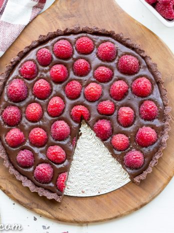 This No-Bake Raspberry Chocolate Tart comes together in just ten minutes! The no-bake chocolate crust is filled with vegan chocolate ganache and topped with fresh raspberries for a decadent, guilt-free treat.