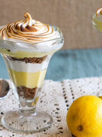 These Lemon Meringue Pie Parfaits are a no-bake dessert that will be your new summer favorite! Lemon curd, graham cracker crumbs, and meringue makes the best individual treats.