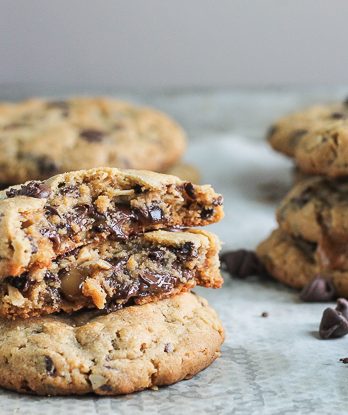 These big Peanut Butter Chocolate Chip Caramel Filled Cookies are soft and chewy peanut butter oatmeal cookies studded with chocolate chips, surrounding a chocolate covered caramel!