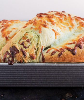 Gooey mozzarella cheese and pesto are swirled throughout a light and fluffy yeast bread to make this Cheesy Pesto Swirl Bread you won't be able to get enough of! Put a slice in the toaster for a delicious snack.