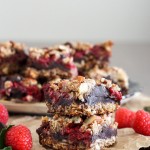 These Raspberry Chocolate Chunk Bars have a crust that doubles as a crumble topping and are loaded with raspberries, dark chocolate, and almonds. This easy recipe is gluten free, refined sugar free, and vegan!