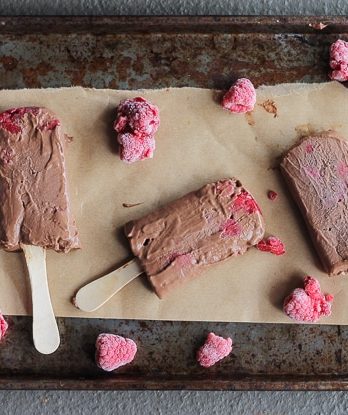 These Chocolate Raspberry Popsicles are a refreshing frozen chocolate treat to enjoy on a hot day. These pops, filled with raspberries, are also vegan!
