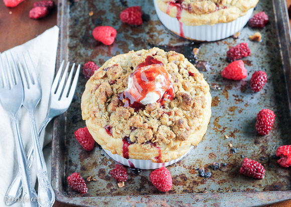 These Mini Apple Berry Crumble Pies are bursting with tart, juicy berries and tender apple slices, topped with a delectably crunchy crumble topping! Serve with ice cream for the best treat.