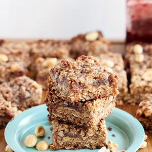 These Peanut Butter & Jelly Bars have a layer of PB&J in the middle, surrounded by a crunchy oatmeal crust. The bars are gluten-free, vegan, and refined sugar-free.