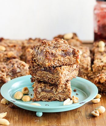 These Peanut Butter & Jelly Bars have a layer of PB&J in the middle, surrounded by a crunchy oatmeal crust. The bars are gluten-free, vegan, and refined sugar-free.