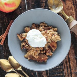 This classic Apple Crisp is made with firm, lightly sweetened and spiced apples and topped with a crispy crumble topping with oats and pecans. It's baked in a skillet and best served with vanilla ice cream!