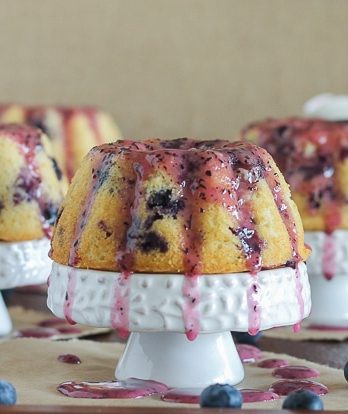 These Mini Lemon Blueberry Bundt Cakes are dripping with fruity blueberry glaze. These mini cakes are small enough so that no one has to share!