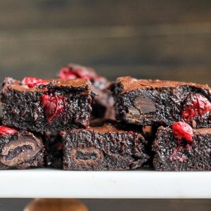 These Cranberry Brownies are made with dark chocolate, fresh and dried cranberries, and dark chocolate covered cranberries! If you love tangy cranberries, you'll love this unique brownie recipe.